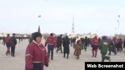 Люди в рабочих спецовках на площади в Жанаозене. 16 декабря 2011 года. Скриншот с видеопортала "Стан.кз".