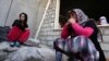 Iraqi Yazidi women who fled the violence in the northern Iraqi town of Sinjar sit outside a school where they are taking shelter in the Kurdish city of Dohuk in Iraq's autonomous Kurdistan region.