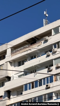Damage is seen on the top floor of the building in Galati