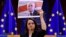 Belarusian opposition leader Svyatlana Tsikhanouskaya delivers a speech as she holds a picture of politician and political prisoner Mikalay Statkevich while receiving the Sakharov human rights prize at the European Parliament in Brussels on December 16.
