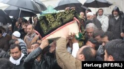 Afghan journalist Sardar Ahmad, his wife, and two children are buried in Kabul on March 23.