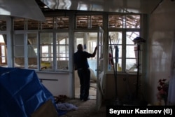 A man surveys the damage to his house in the village of Gazyan, near the front lines of the current fighting.