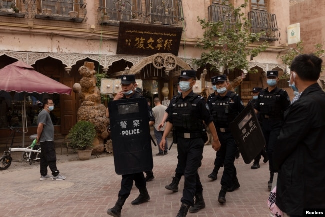 Police officers patrol the old city in Kashgar in China's Xinjiang Uyghur Autonomous Region.
