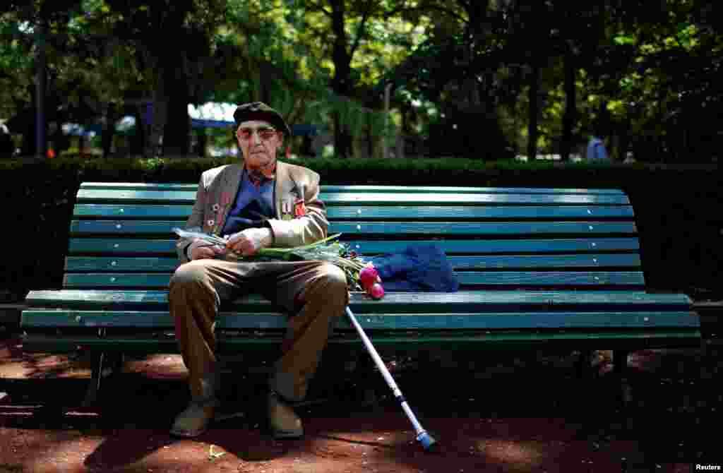 World War II veteran Yury Podgorski, 93, sits on a bench during Victory Day commemorations in Tbilisi, Georgia, on May 9. (Reuters/David Mdzinarishvili)