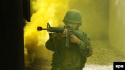 An Afghan soldier aims his gun during a training session in Kabul. The new NATO-led mission is focused on training Afghan security forces.