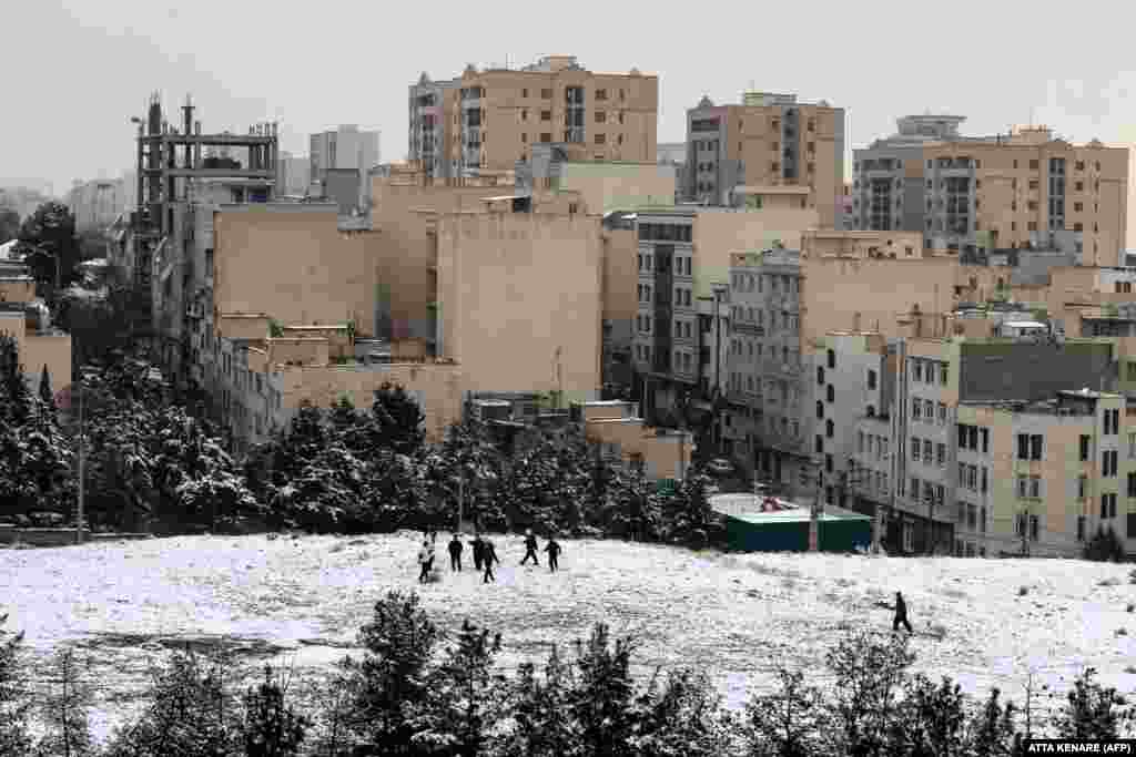 Boys play in the snow in a suburb of Tehran on January 20.Images such as this, released by photographers accredited to work in Iran, emphasize a return to normal life after the violence of recent days, but sources told RFE/RL's Radio Farda on January 17 that Tehran is effectively under martial law, with people being stopped at random and having their phones inspected for links to the protests.