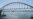 Sailboats pass under the newly installed arch on Russia's bridge under construction to Crimea.