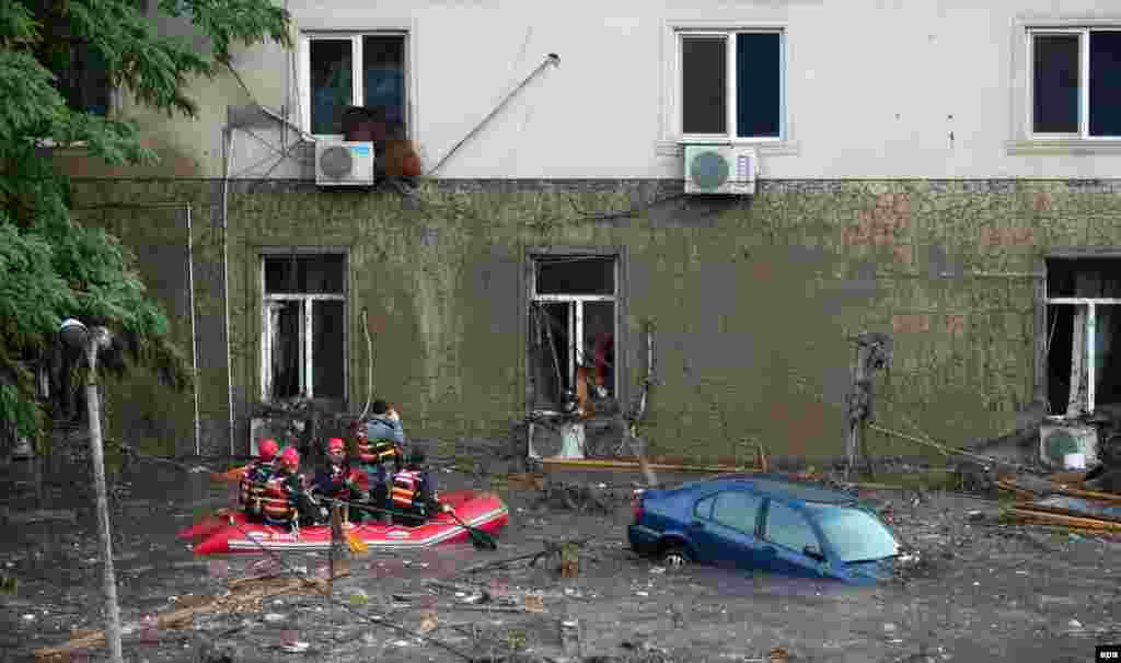 Rescuers try to figure out what to do with a runaway bear that found itself perched precariously on the ledge of a flooded building on a Tbilisi street after a deadly flash flood. Police have shot dead several animals over safety concerns, with six wolves killed at a children's hospital, according to broadcaster Rustavi 2.