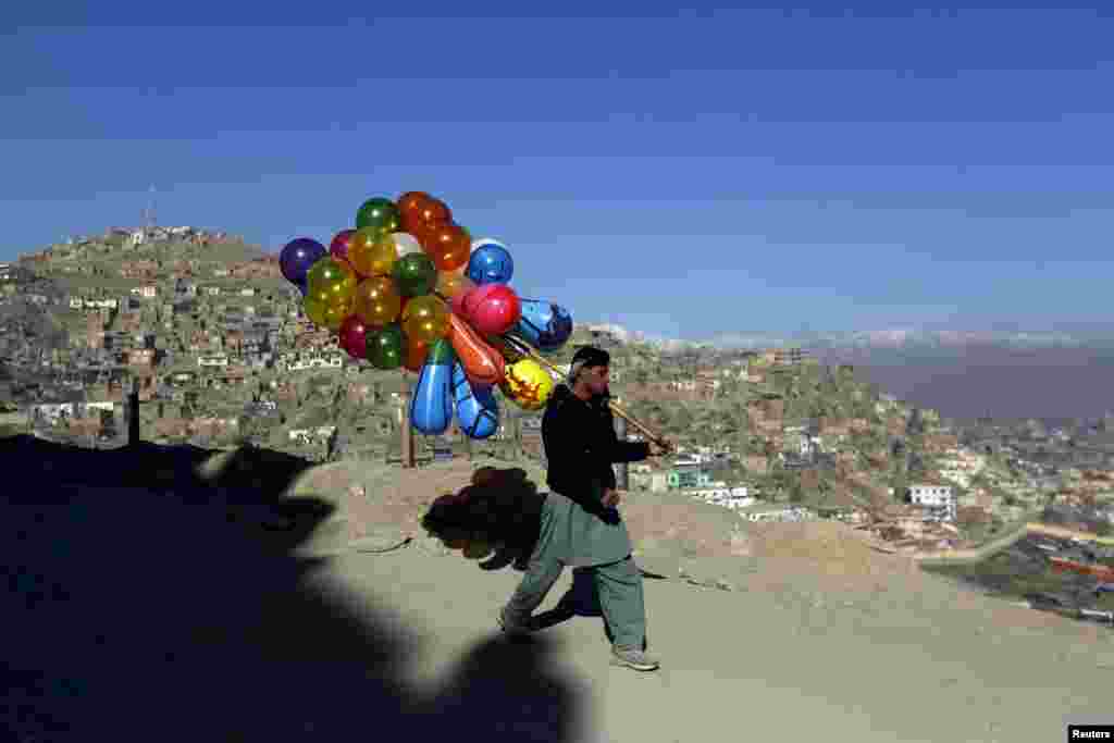 An Afghan man holds balloons for sale in Kabul. (Reuters/Mohammad Ismail)