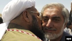 Passions have been inflamed in Afghanistan after a running mate of presidential candidate Abdullah Abdullah (right) was photographed commemorating the death of former Iranian Supreme Leader Ayatollah Khomeini. (file photo)
