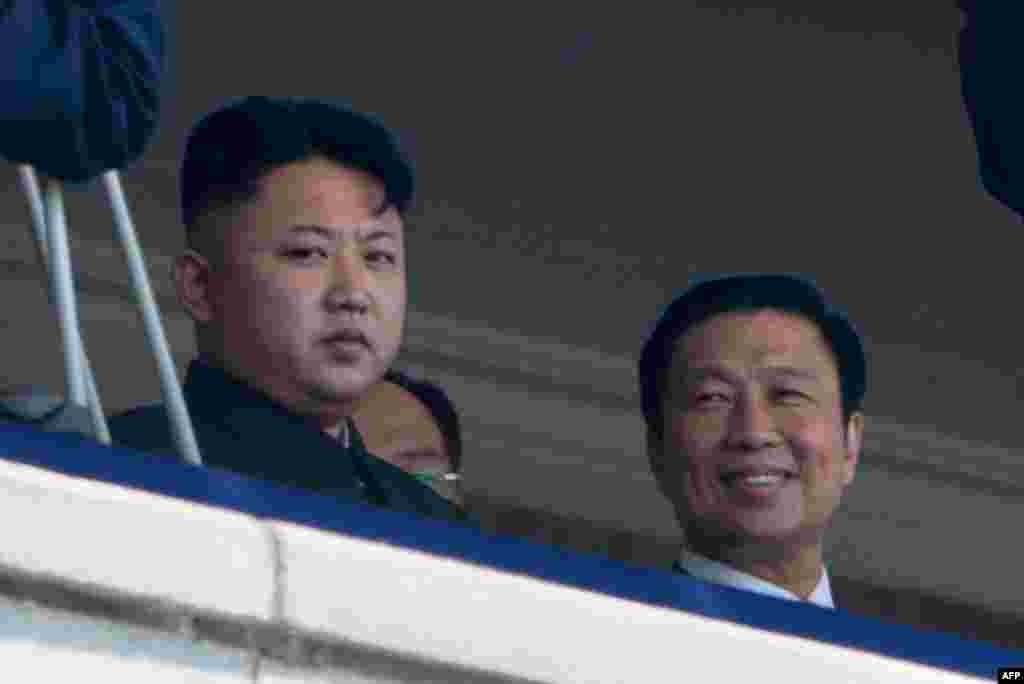 North Korean leader Kim Jong Un (left) sits with China&#39;s Vice President Li Yuanchao (right) during the military parade.