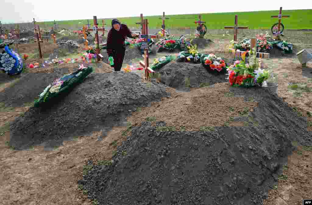 A woman tends a grave at a cemetery in Ceadir-Lunga.