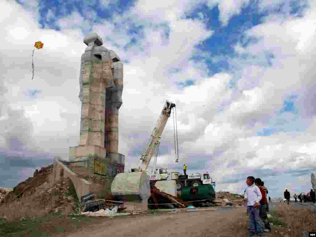 Turkish children play in front of the unfinished statue of "Peace and Brotherhood" in Kars, near the border with Armenia. Local officials decided in February to demolish the monument. Photo by EPA.
