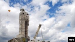 Children play in front of the unfinished "Peace and Brotherhood" sculpture in Kars on April 24.