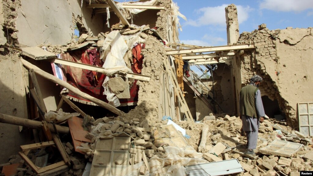 An Afghan man inspects a house destroyed during clashes between Afghan security forces and the Taliban in Kunduz in November.