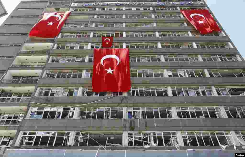 Turkish flags hang on the facade of the damaged building of police headquarters in Ankara, Turkey, following the failed coup attempt last weekend. (Reuters/Osman Orsal)