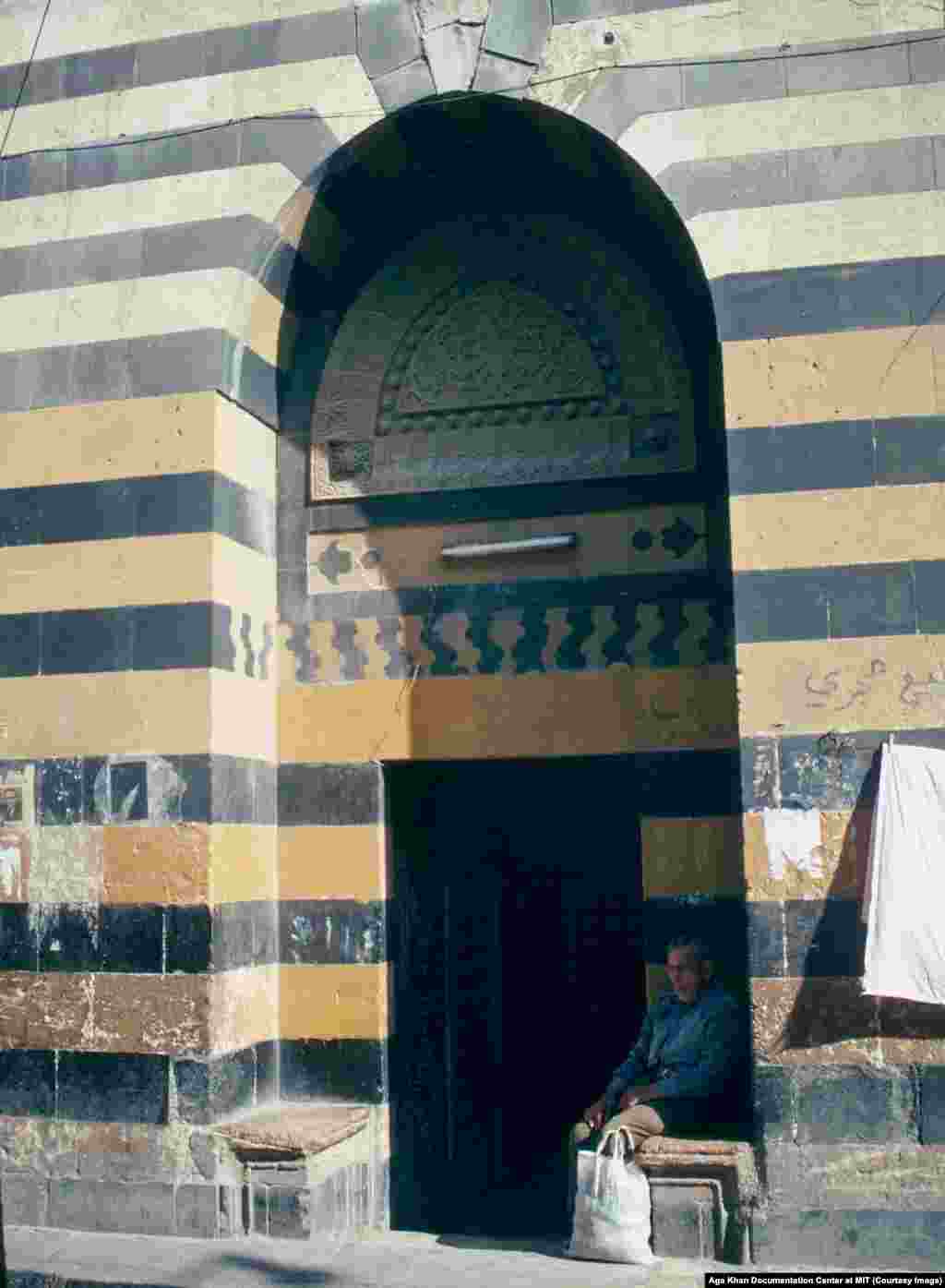 The entrance to a bathhouse in Aleppo in 1991. A degree of stability returned to Syria under Hafez al-Assad, but the tactics of his security services were ruthless.