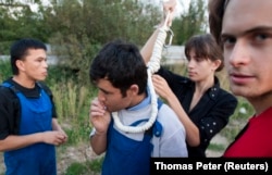 Verzilov (right) and Nadezhda Tolokonnikova prepare a migrant worker for a mock execution in September 2008.