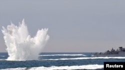 A South Korean patrol boat dropping a depth charge during a drill off the western coastal town of Taean on May 27.