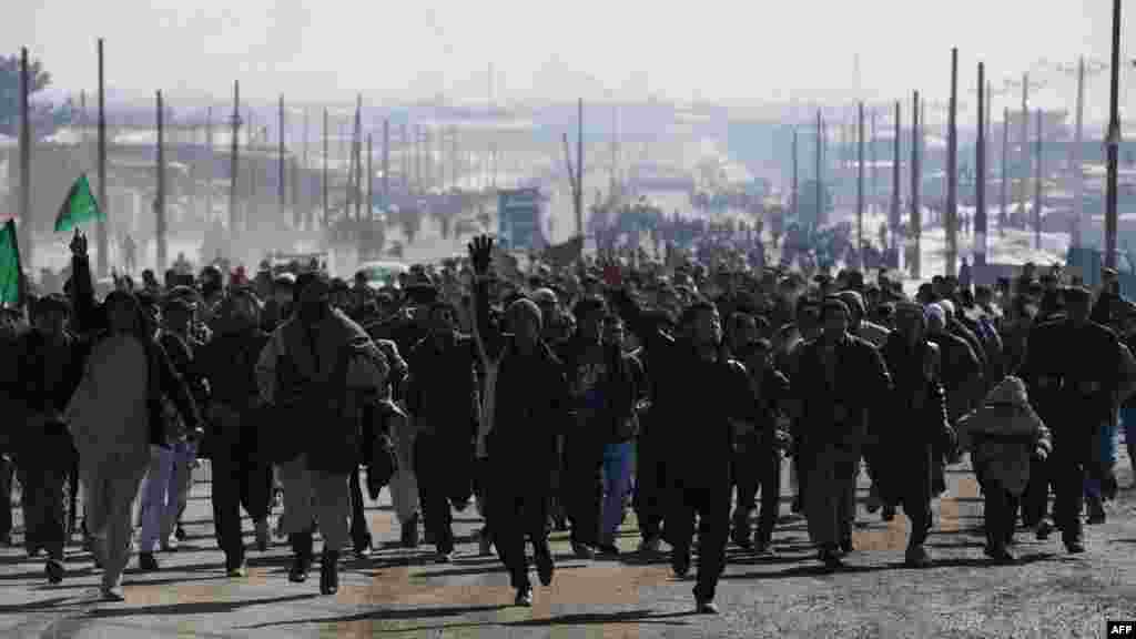 Afghan demonstrators run as they shout anti-U.S. slogans during a protest in Kabul against ISAF Koran desecrations. (REUTERS/Ahmed Jadallah)