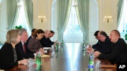 Azerbaijan -- U.S. National security adviser John Bolton, second left, and Azerbaijan's President Ilham Aliyev, right, during talks in Baku, Azerbaijan, Wednesday, Oct. 24, 2018.