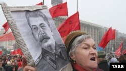 A Ukrainian Communist Party supporter holds a portrait of Stalin in Kyiv. Some Ukrainians credit Stalin with saving Ukraine from fascism in World War II.