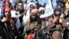 FILE: Afghan Taliban militants and villagers attend a gathering as they celebrate the peace U.S. in Alingar, a district of the eastern Laghman Province in March