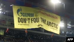 Greenpeace activists deploy a banner to protest against Russia's Gazprom during the Champions League soccer match in Basel on October 1. Gazprom is a sponsor of the competition, as well as German club FC Schalke, which was playing FC Basel.