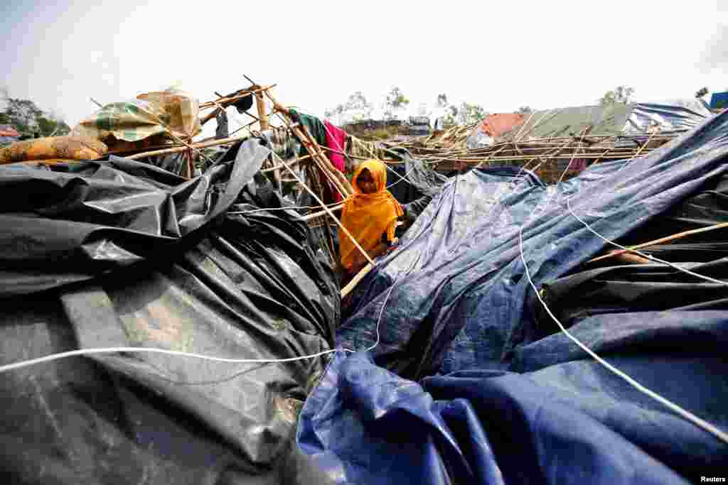 Ayesha, 16, a Rohingya refugee girl, poses for a photograph in her house, which has been destroyed by Cyclone Mora at the Balukhali makeshift refugee camp in Cox&#39;s Bazar, Bangladesh, on May 31. (Reuters/Muhammad Ponir Hossain)