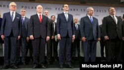 Mateusz Morawiecki, Israeli Prime Minister Benjamin Netanyahu and United State Secretary of State Mike Pompeo, from left, stand on a podium at a conference on Peace and Security in the Middle East in Warsaw, Poland, Thursday, Feb. 14, 2019.