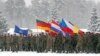 LITHUANIA -- Soldiers hold the country flags of the NATO enhanced Forward Presence (eFP) battle group in Rukla military base, February 4, 2019