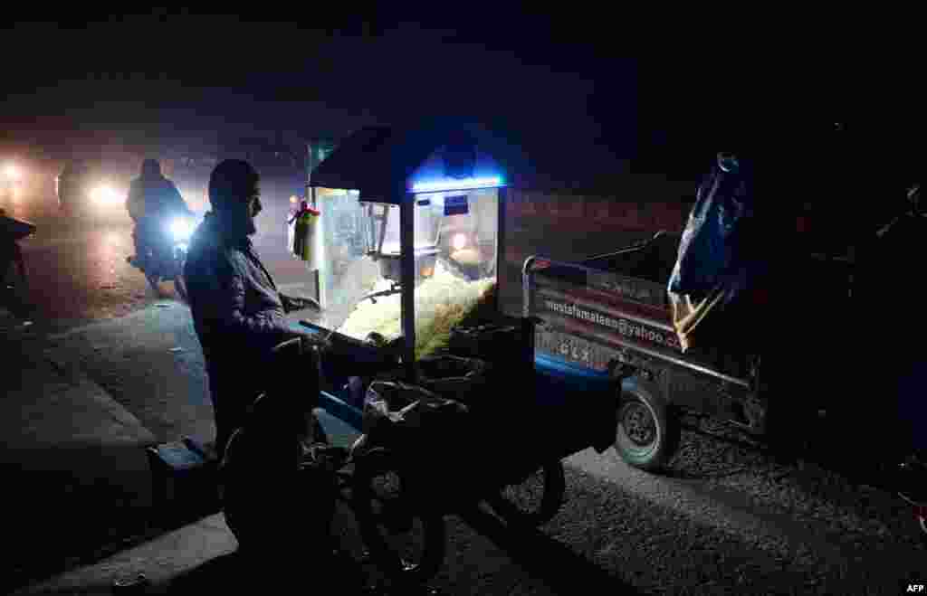 A roadside popcorn vendor waits for customers in Jalalabad, Afghanistan. (AFP/Noorullah Shirzada)