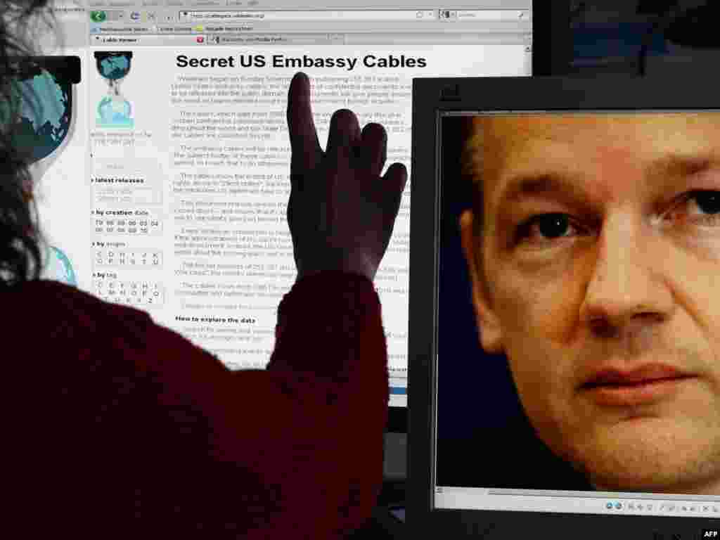 Germany - A woman watching the internet site of WikiLeaks as on the screen at (R) can be seen a photo of WikiLeaks-founder Julian Assange, Schwerin, 30Nov2010 - This illustration taken on November 30, 2010 in Schwerin, northeastern Germany, shows a woman watching the internet site of WikiLeaks as on the screen at (R) can be seen a photo of WikiLeaks-founder Julian Assange. WikiLeaks faced a worldwide backlash over its release of secret US diplomatic cables, with some countries saying the revelations undermined diplomacy while others dismissed them as worthless 10poty