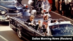 U.S. President John F. Kennedy (left), first lady Jaqueline Kennedy (right), and Texas Governor John Connally ride in a limousine moments before Kennedy was assassinated in Dallas, Texas, on November 22, 1963.