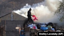 NAGORNO-KARABAKH -- A man loads possessions on his truck after setting his home on fire in Kelbajar (Karvachar), November 13, 2020.