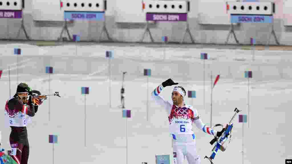 Winner Martin Fourcade of France (right) reacts after the last shooting during the biathlon 12.5-kilometer pursuit competition at Krasnaya Polyana.