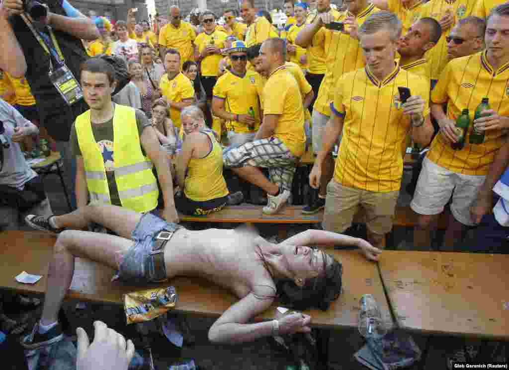 Shachko in front of Swedish football fans as she protests against prostitution during the UEFA Euro 2012 football championship in Kyiv.&nbsp;