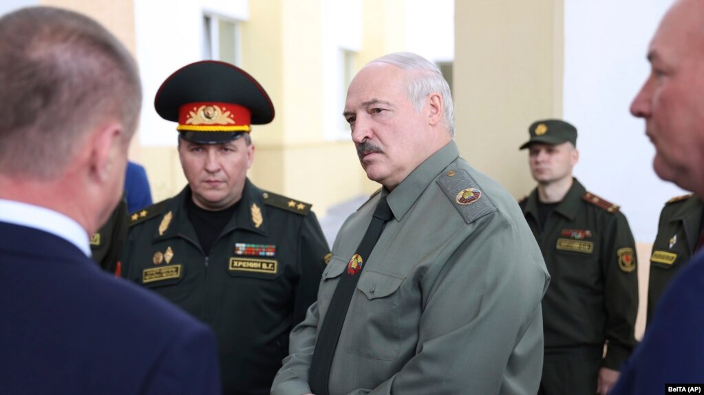 Belarusian President Alyaksandr Lukashenka (center) attends a meeting on territorial defense issues in the town of Shklov in June with Defense Minister Viktar Khrenin (left).