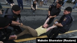 Police detain a participant of a rally in support of Russian investigative journalist Ivan Golunov in Moscow on June 12.