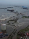 Tsunami waves flood an area after a powerful magnitude 8.8 earthquake struck off Russia's far eastern Kamchatka Peninsula, in Severo-Kurilsk