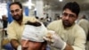 Pakistani paramedics treat a man injured in an earthquake at a hospital in Peshawar on October 26.