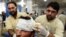 Pakistani paramedics treat a man injured in an earthquake at a hospital in Peshawar on October 26.