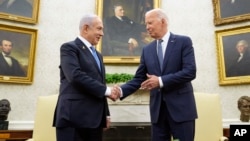 U.S. President Joe Biden (right) shakes hands with Israeli Prime Minister Benjamin Netanyahu at the White House in July. 