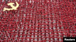 Students in school uniforms linked arms to form the flag of the Communist Party of China in celebration of the party's 90th anniversary in 2011.