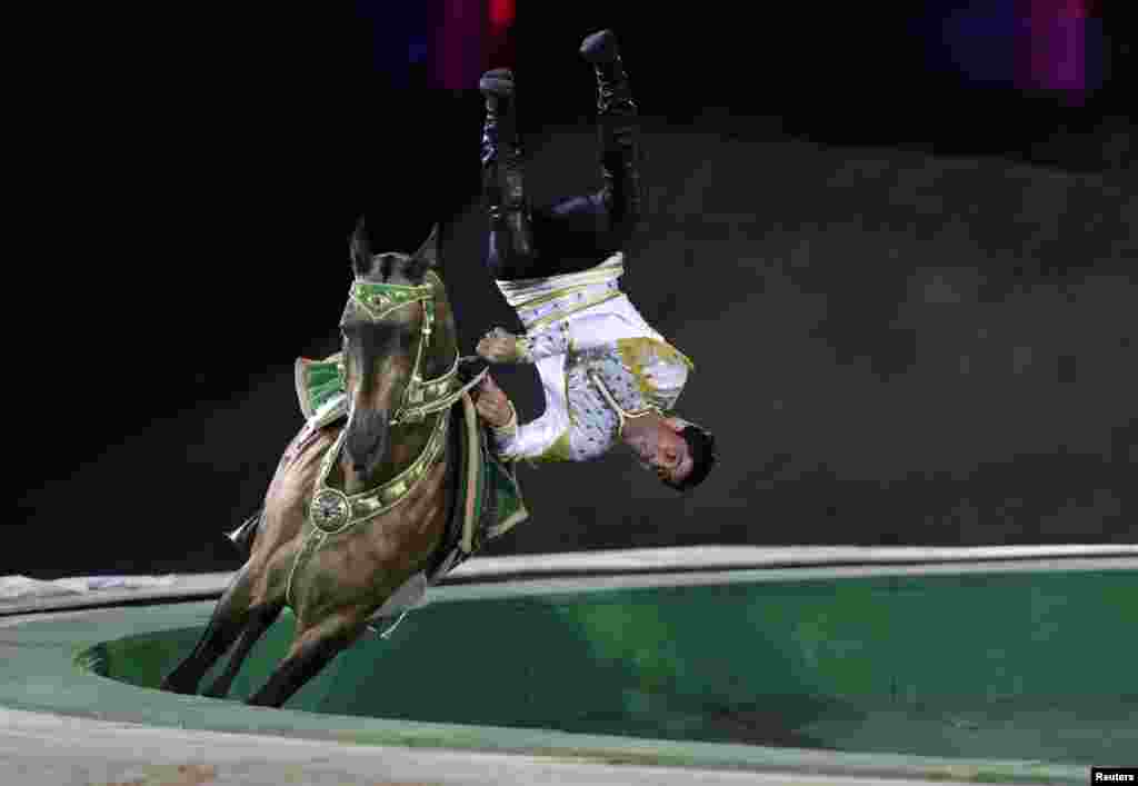 A Turkmen man performs on a horse during the opening ceremony of 2014 International Akhal-Teke Horses Association Special Conference and China Horse Culture Festival at the Forbidden City in Beijing on May 12. (Reuters/Jason Lee)
