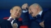 Russian President Vladimir Putin (left) and Belarusian President Alyaksandr Lukashenka speak in the stands during a ceremony in Minsk in June 2019.