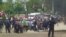 Protesters gather as smoke rises near the main point of confrontation with police on the main road to Kumtor gold mine on May 31, when clashes injured dozens of people.