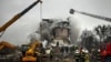 Rescuers work at the site of an apartment building that was hit by a Russian missile strike in Poltava on February 1. 