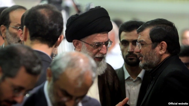 Iranian Supreme leader Ali Khamenei meets the father of Mohsen Rouholamini, undated.
