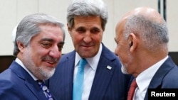 U.S. Secretary of State John Kerry (center) talks with Afghan President Ashraf Ghani (right) and Chief Executive Abdullah Abdullah during a NATO meeting in Brussels on December 2.